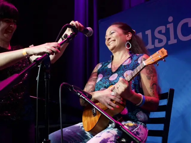 An Adult Getting Read to Perform with a Ukulele