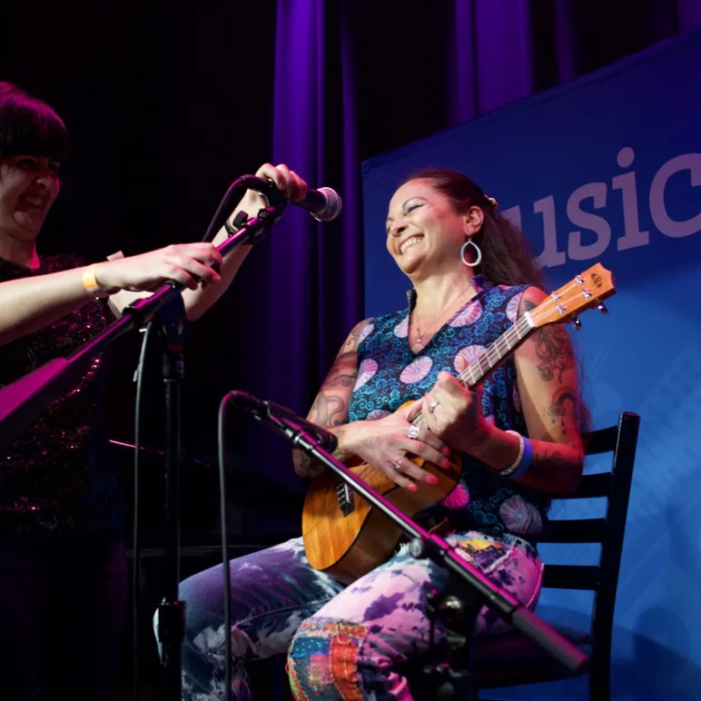An Adult Getting Read to Perform with a Ukulele