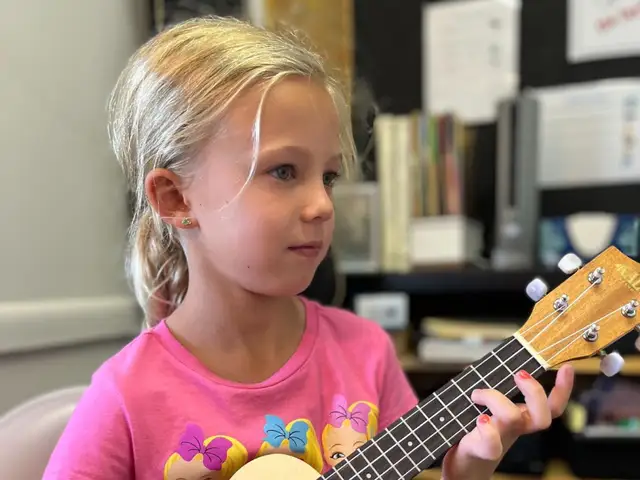 Girl Practicing a Ukulele