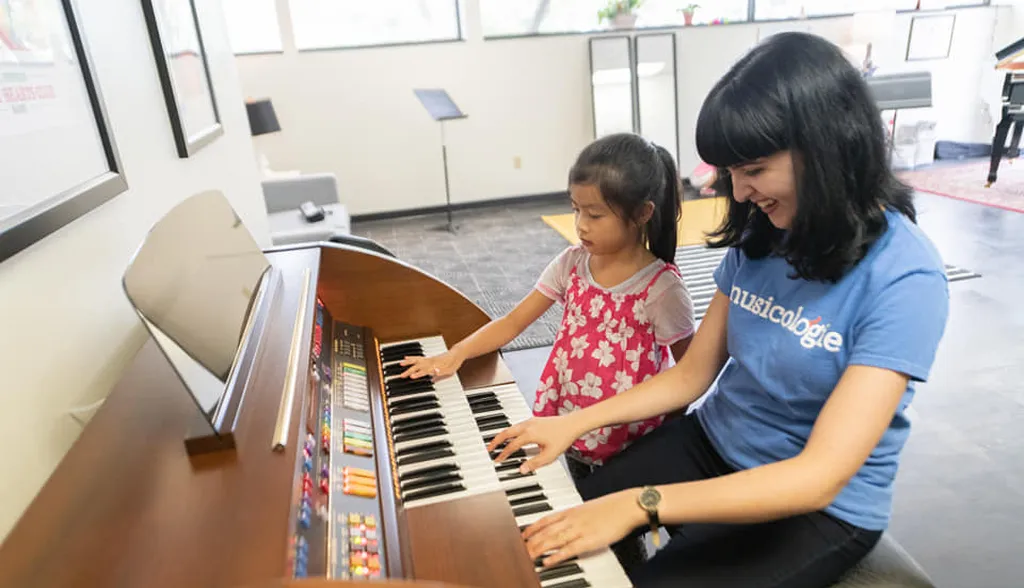 Teacher playing the organ with a student