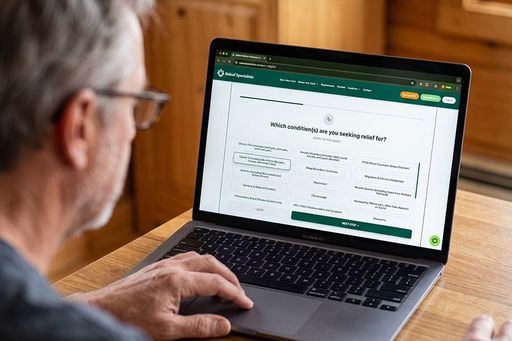 A quick and easy medical cannabis card application with Releaf Specialists. Someone using his laptop to apply for a medical cannabis card through Releaf Specialists, a top choice for fast and easy applications across several states.