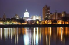 Capitol building at night with reflection in water