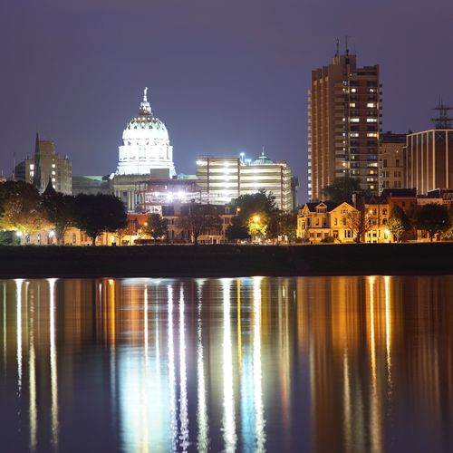 Capitol building at night with reflection in water