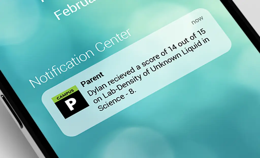 Smartphone screen showing a notification: "Dylan received a score of 14 out of 15 on Lab-Density of Unknown Liquid in Science-8."