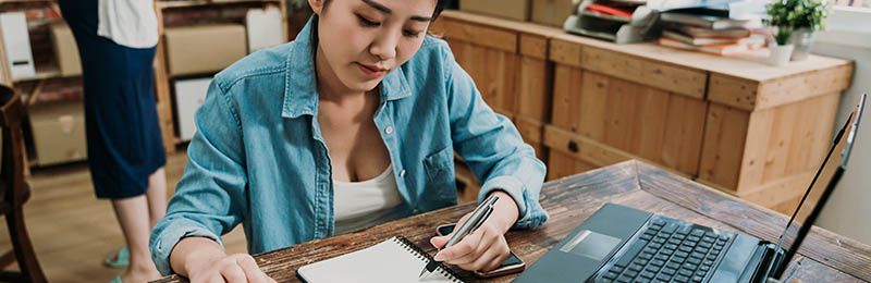 Female entrepreneur working on her business plan using LivePlan's new AI-powered features. Female entrepreneur working on her business plan using LivePlan's new AI-powered features.