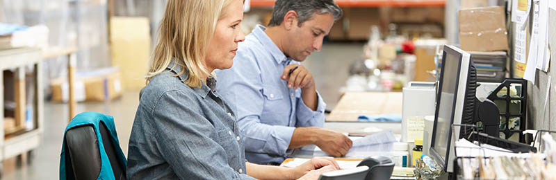 man and woman working on computers