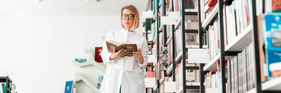 Female entrepreneur in her home office looking at ipad to review her notes that she has prepared for her business plan writer. Female entrepreneur in her home office looking at ipad to review her notes that she has prepared for her business plan writer.