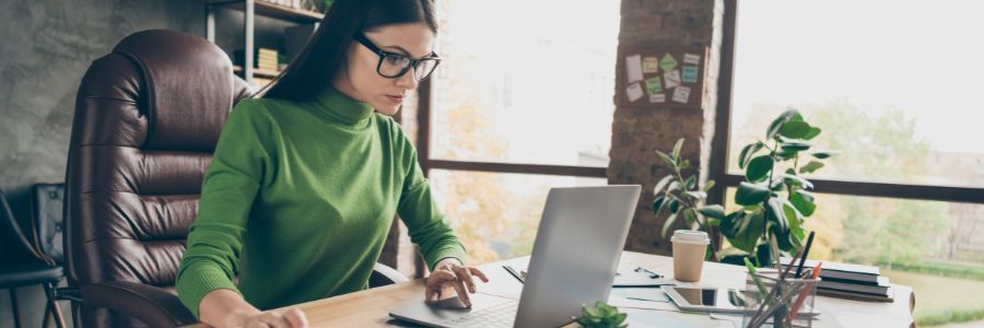 Female entrepreneur working in her home office on cloud accounting software and exploring her financials. Female entrepreneur working in her home office on cloud accounting software and exploring her financials.
