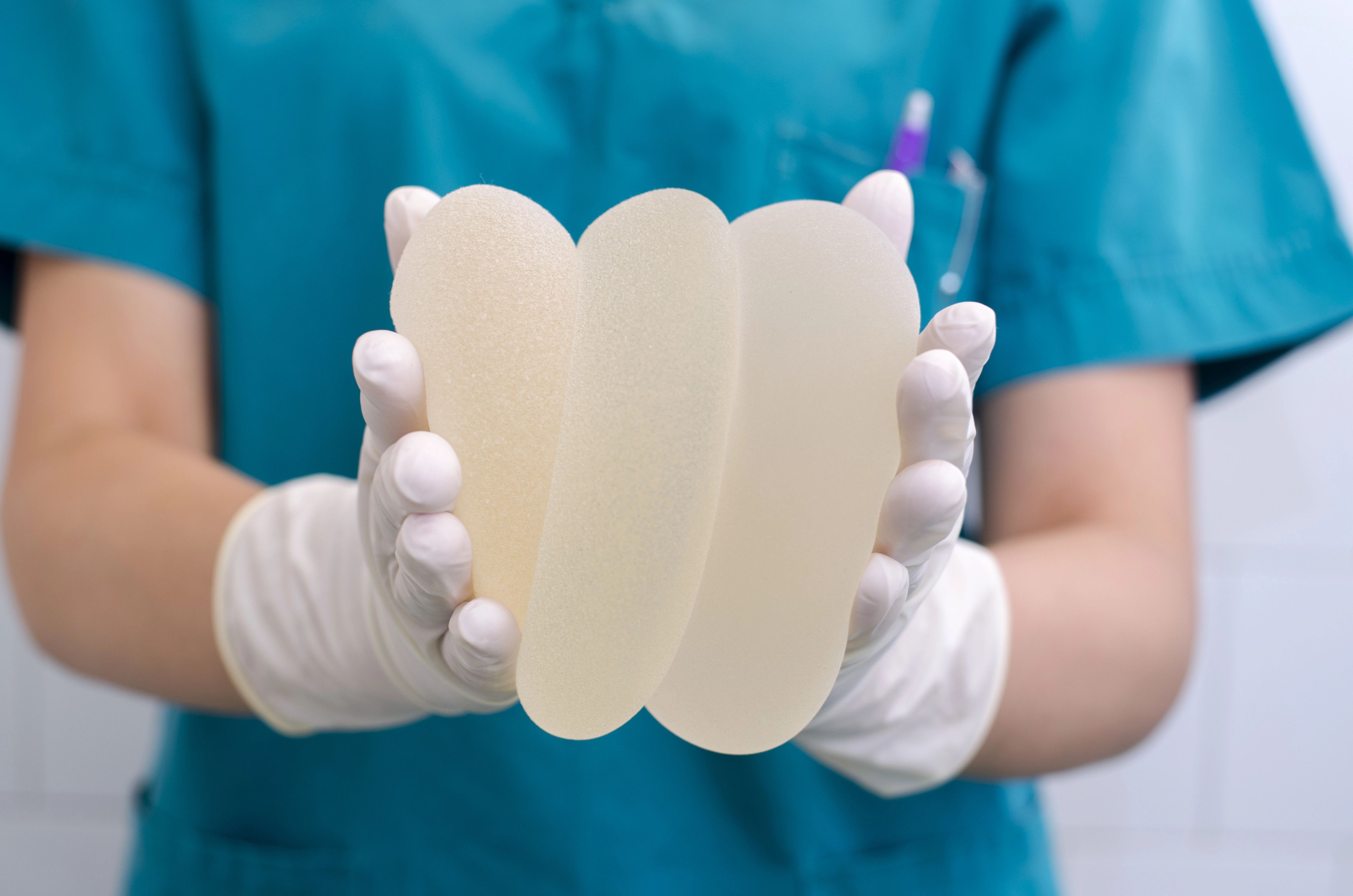 DR holding together different breast implants