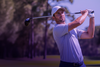 Golfer mid-swing on a stylised purple gradient background, used as an email article cover