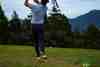 Golfer practising iron shots at the driving range, building distance control through repetition