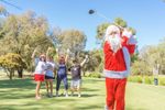 Golfers enjoying summer Christmas Day golf on Australian course with blue skies.