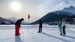 St. Moritz snow golf is an annual event in the Swiss Alps where players hit golf balls on a course set up on the frozen Lake St. Moritz.