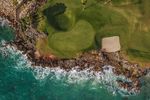 The iconic 5th hole challenges groups with its all-or-nothing carry over Caribbean waters.