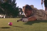 Kevin Costner as Roy McAvoy lining up a putt on the green in Tin Cup