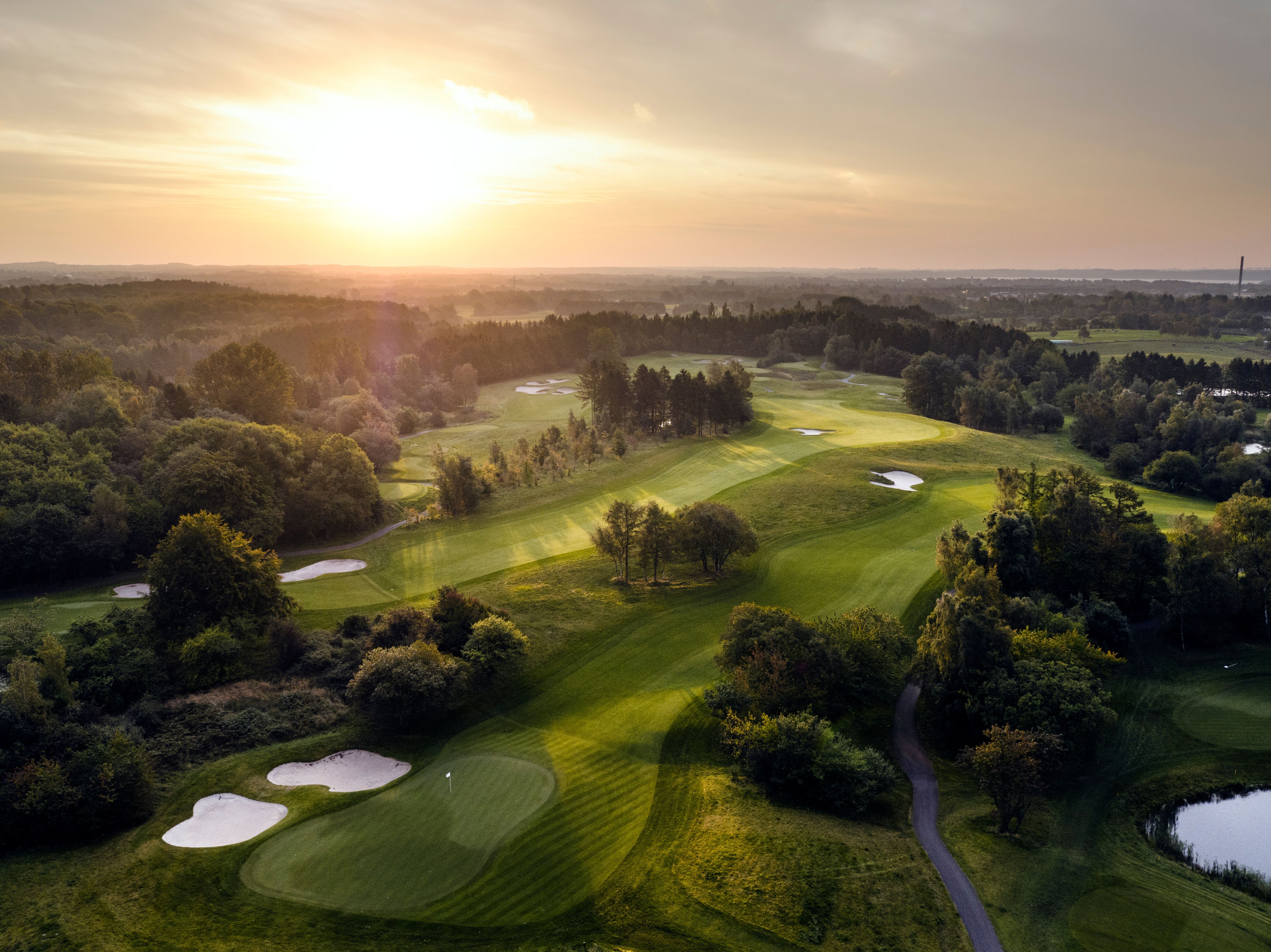 Aerial view of the parkland fairways and bunkers at Rungsted Golf Klub near Copenhagen at sunrise