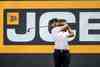 Golfer hits a shot in front of JCB hoarding at LIV Golf UK
