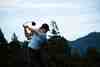 Golfer at the top of the backswing on a practice tee