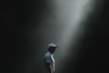 Golfer standing in a shaft of light, focused before a shot