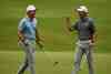 Two golfers celebrating together on the course