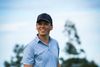 Smiling golfer holding a club on a mountain course