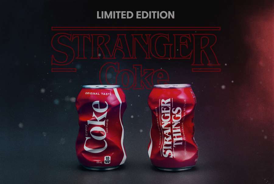 The image shows two cans of Stranger Things limited edition Coca-Cola, displaying the Stranger Things branding and logo.