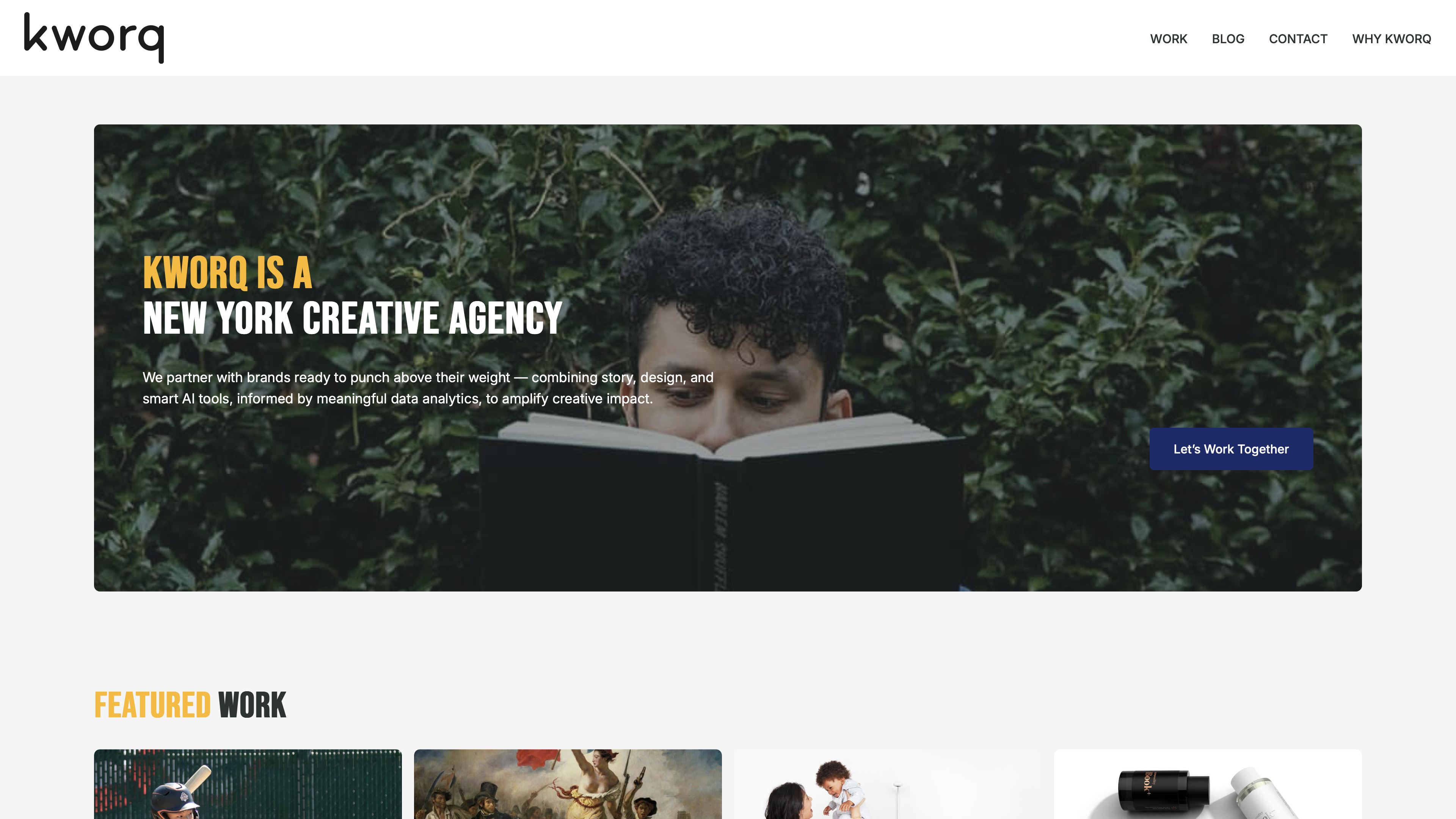 A person with curly hair reads a book while surrounded by lush green foliage.