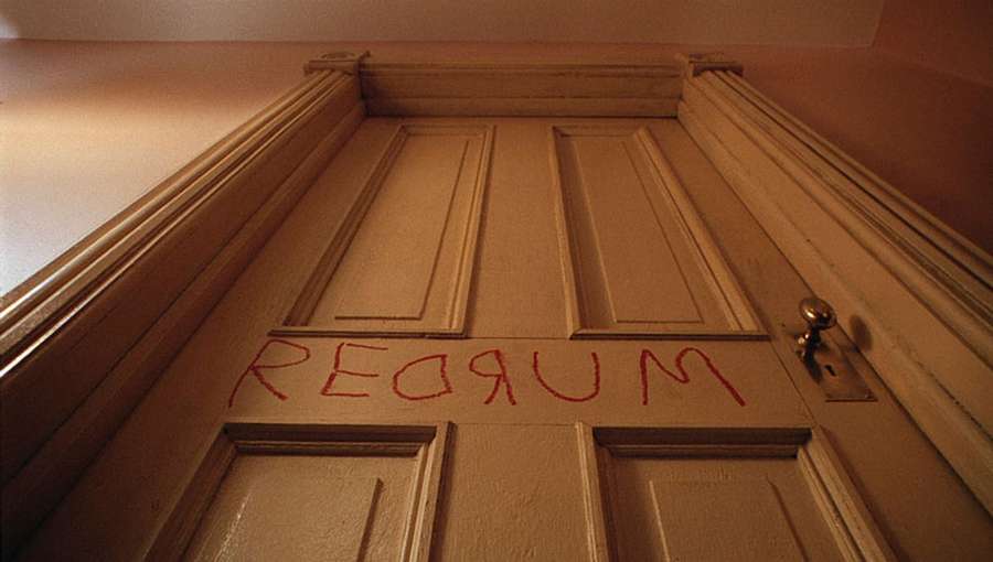 The image shows the interior of a door with the word "Redrum" written on it in red text.