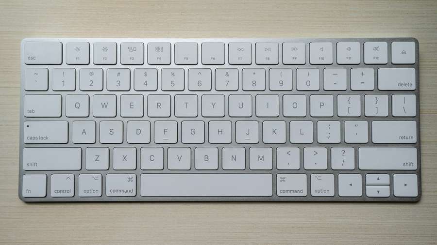 Bright white computer keyboard on a yellow background