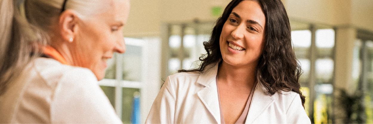 smiling woman doctor talking to a colleague