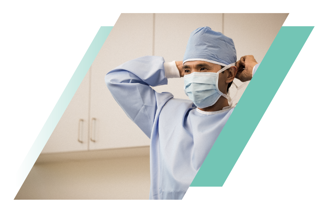 Physician putting on a mask in an emergency room
