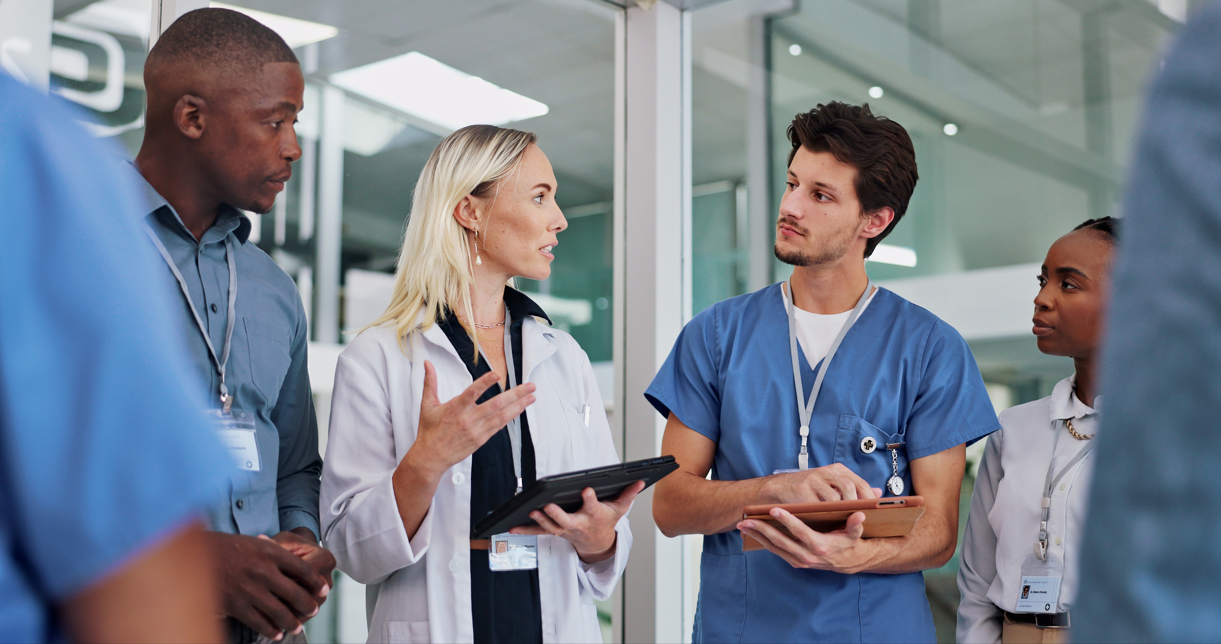 Physicians talk to each other in the hallway of a hospital