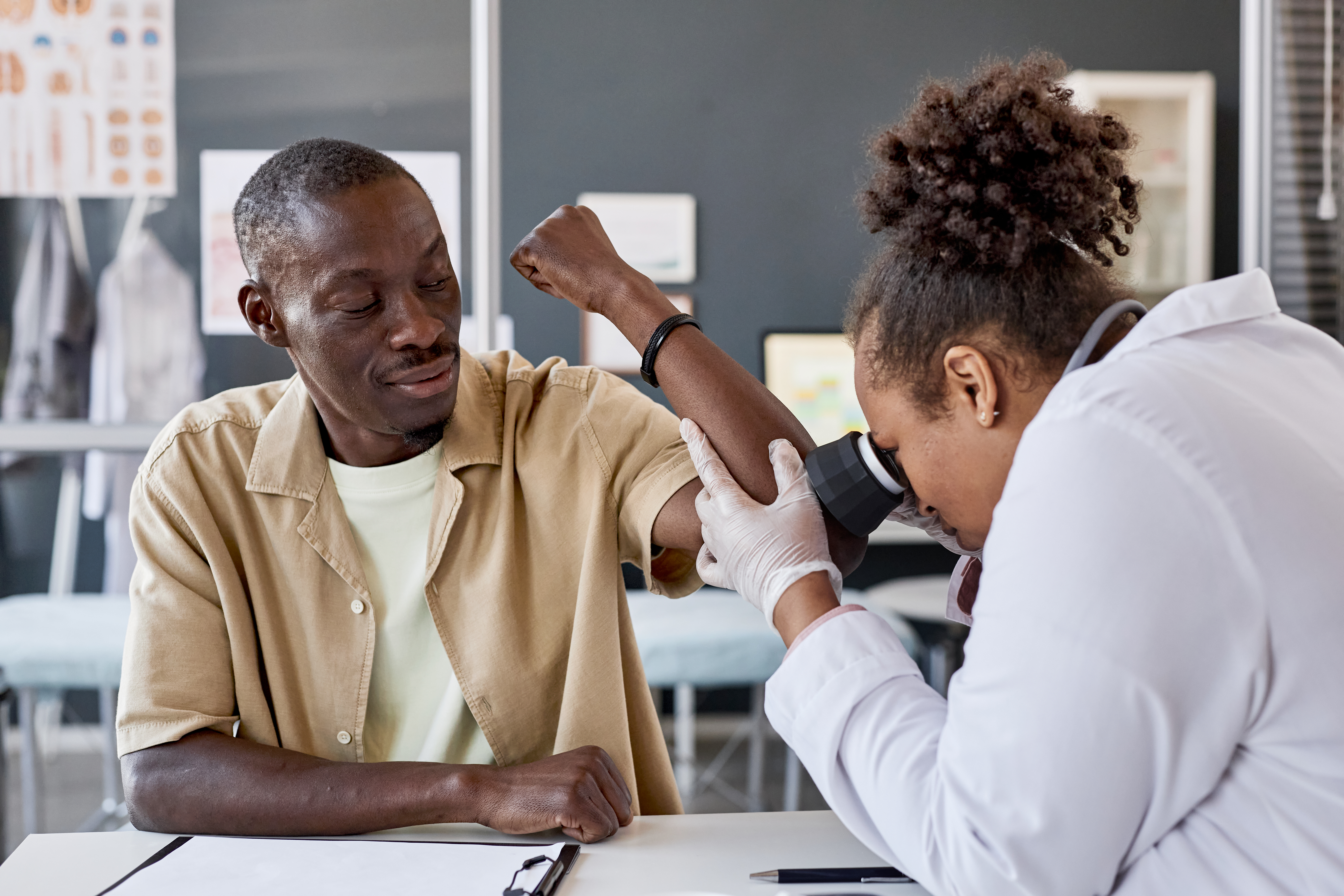 dermatologist giving patient an exam