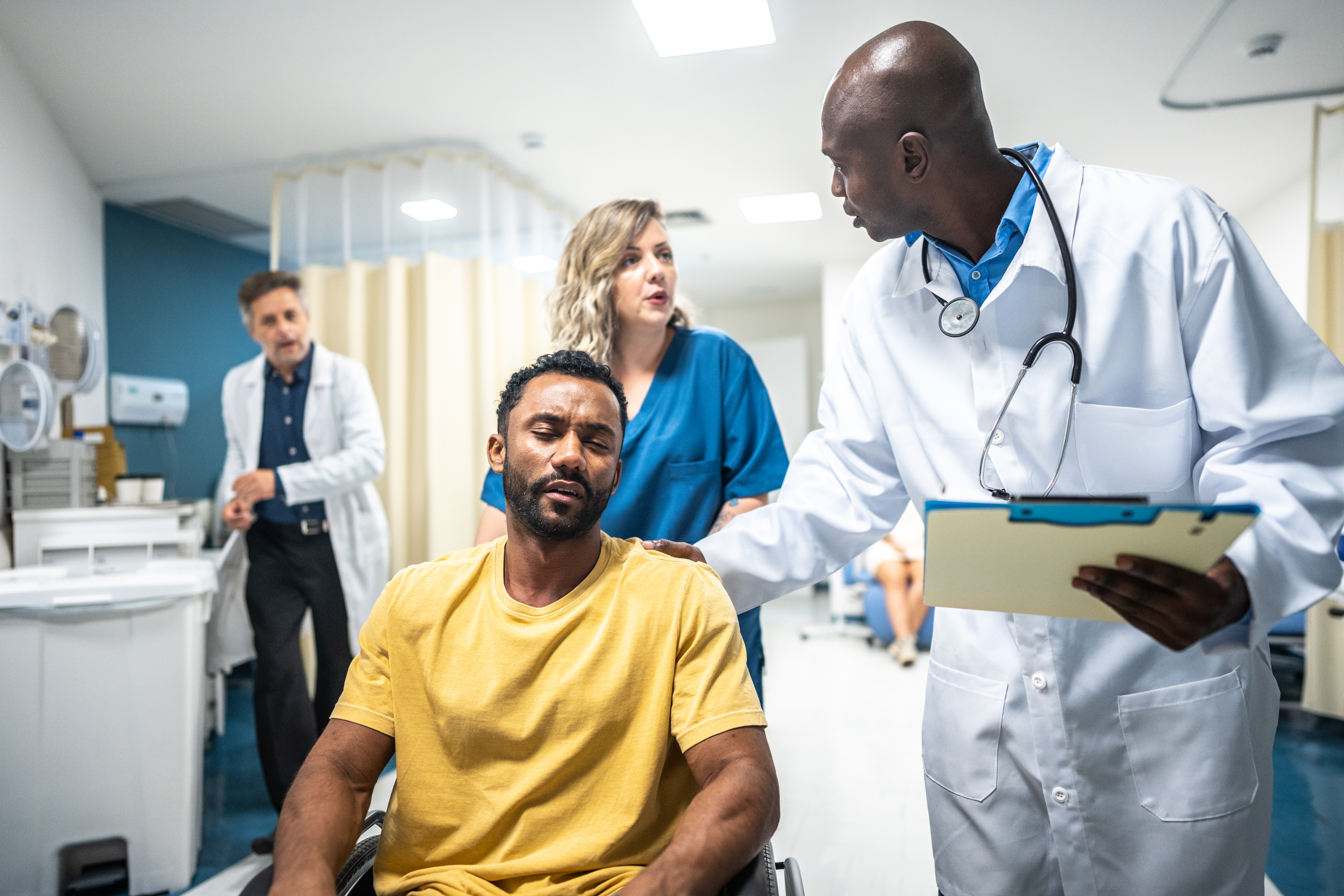 Emergency room physicians with patient in ER