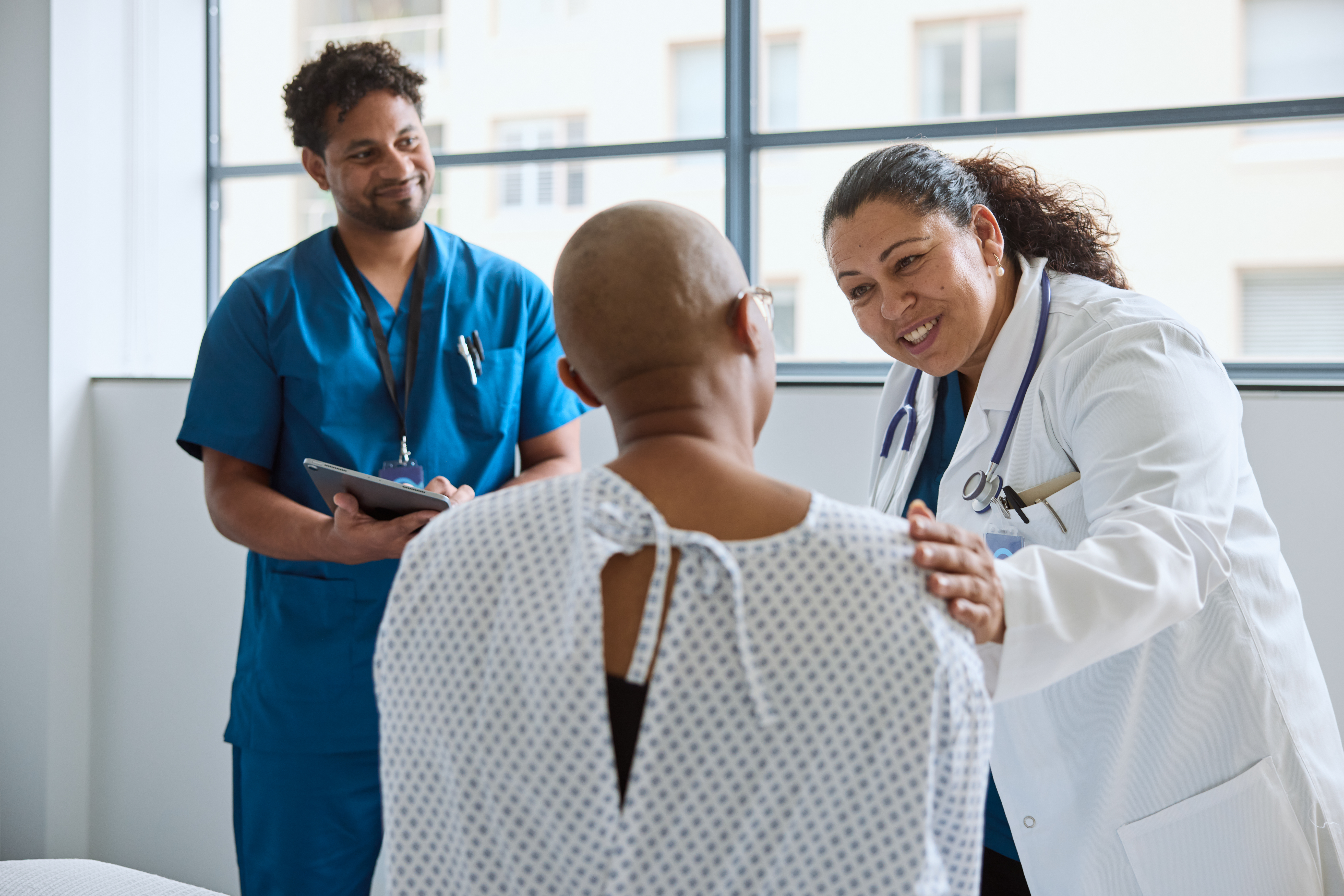 Medical oncologist with nurse and patient