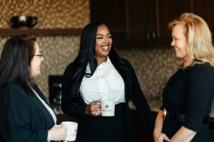 Three business women talking over coffee in the Efficient office