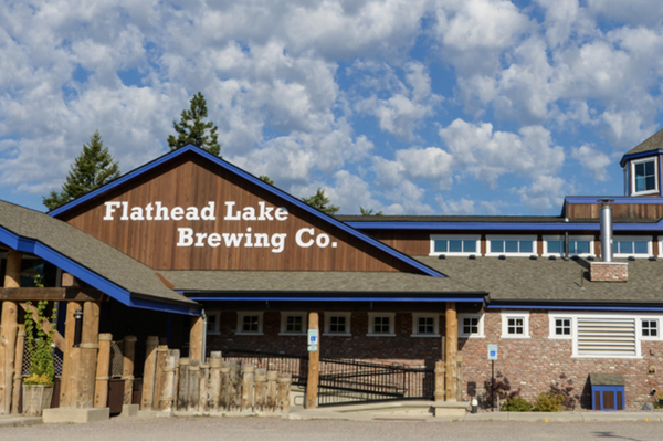 Flathhead Lake Brewing Co. building in Montana with a sign reading “Flathhead Lake Brewing Co.”