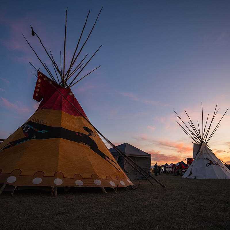 Tipis at a Native American gathering at sunset in Montana