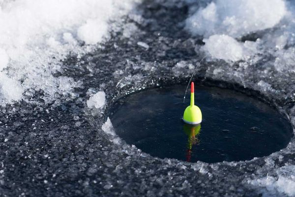 Float bobber in a black fishing hole amid churning whitewater rapids in Montana