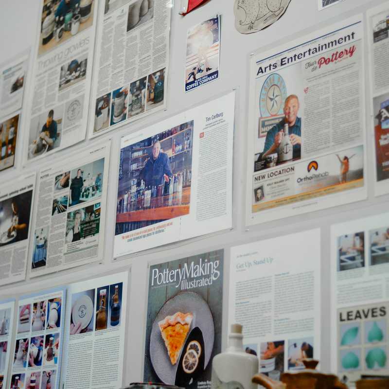 Flyer and poster boards covered with photos, event listings, and advertisements in a public indoor space