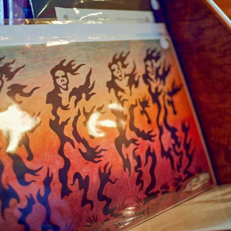Painted dragon design on a guitar display at a Montana arts market