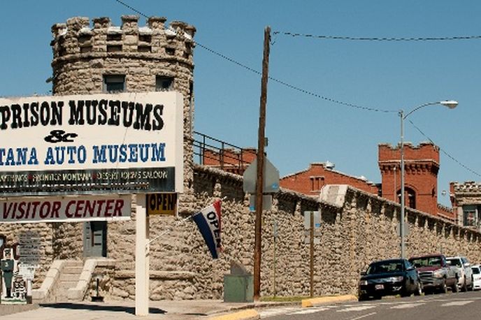 Old Prison Museums and Montana Auto Museum visitor center sign and entrance along a street in the historic prison grounds