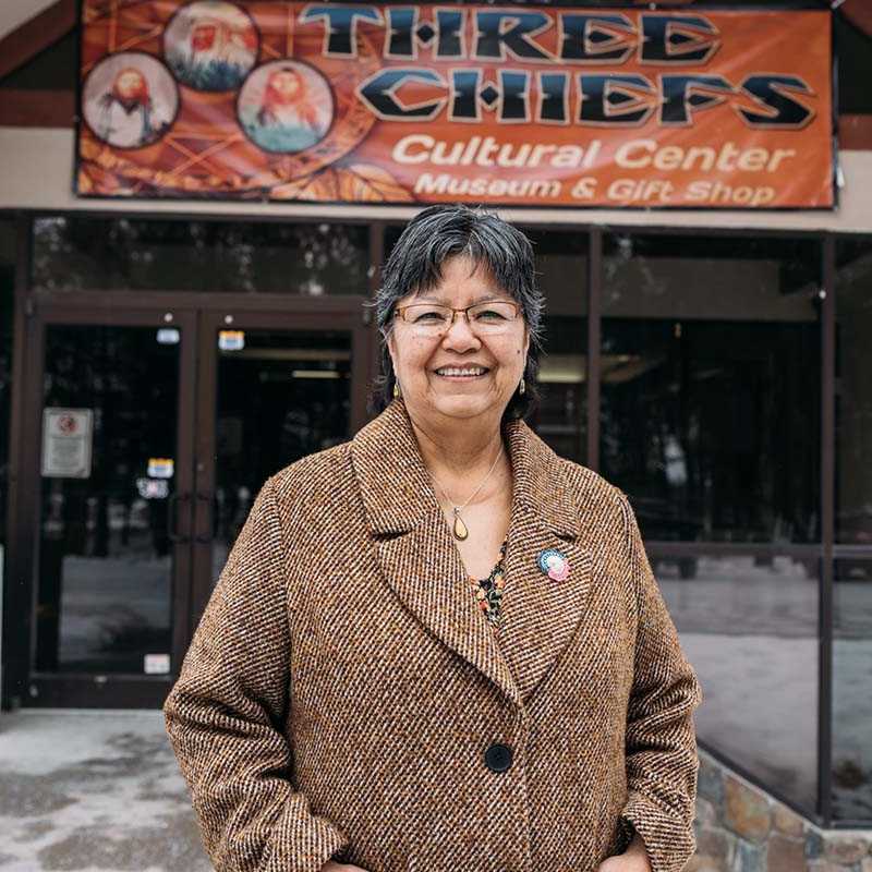 Woman standing outside the Tibbetts Cultural Center Museum and Gift Shop in Montana