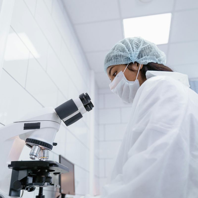A Researcher using a Microscope