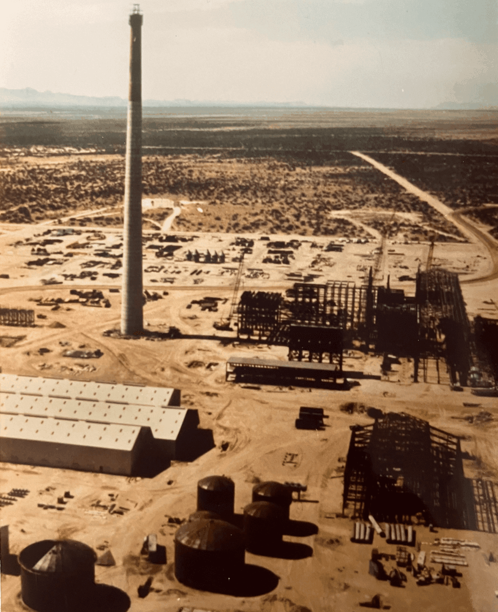 Old image of an aerial view of a large construction site in a desert area.