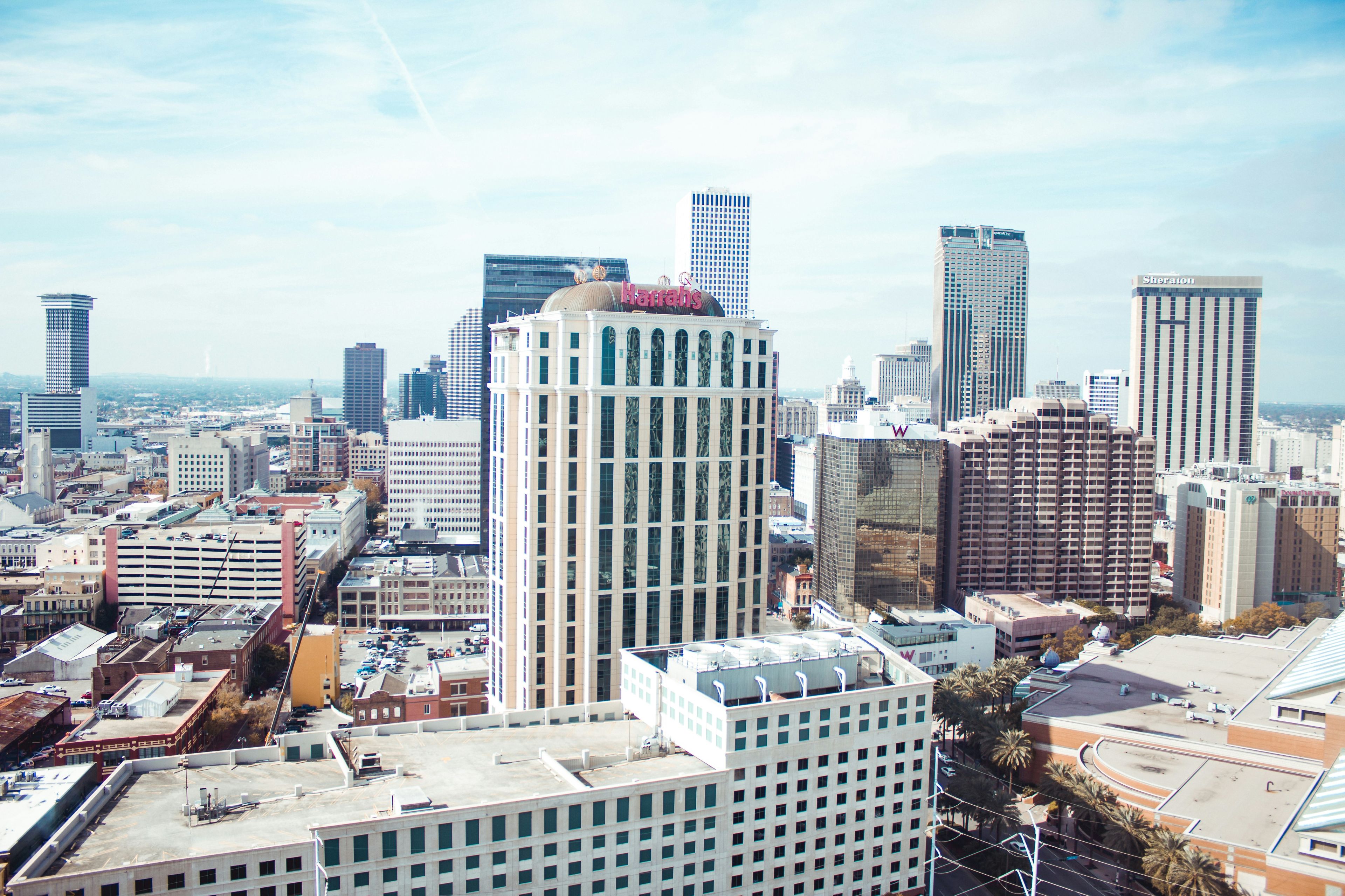 Aerial view of downtown New Orleans, Louisiana, with Harrah’s building and surrounding skyscrapers on a sunny day.