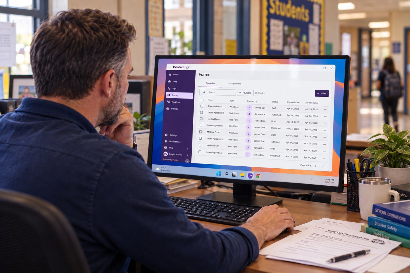School staff member reviewing a forms dashboard on a desktop monitor