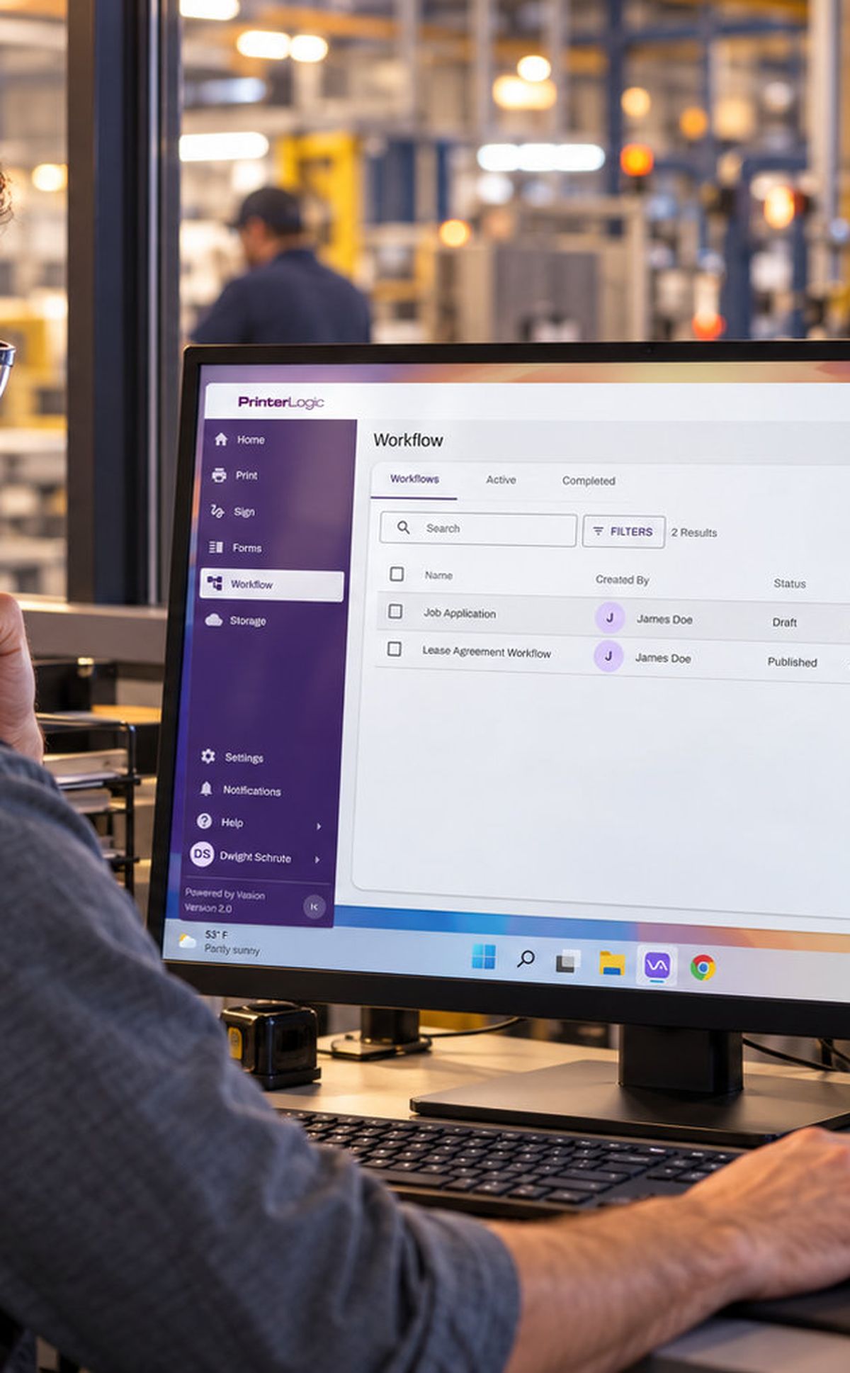 Warehouse worker reviewing output on a monitor