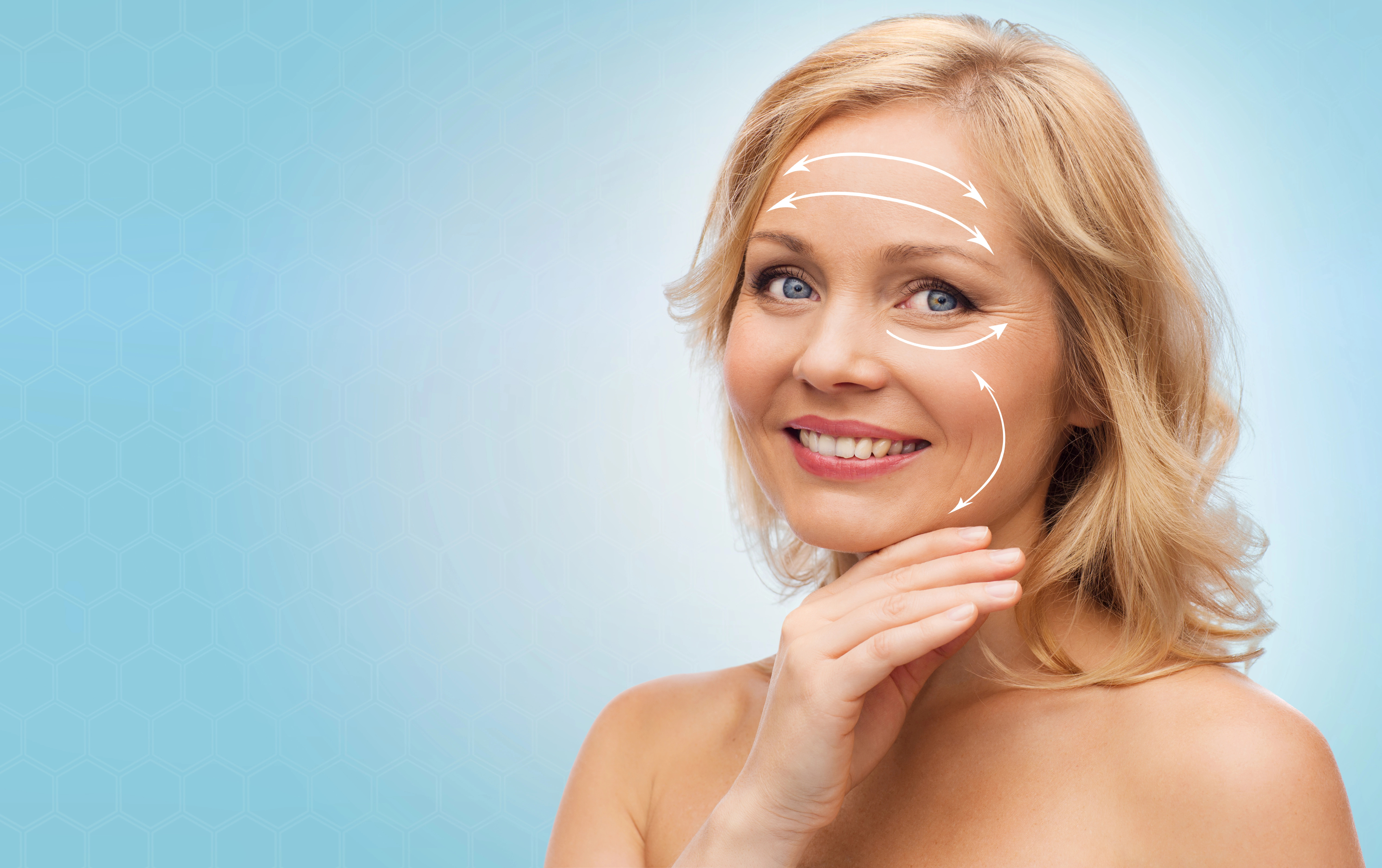 Smiling woman touching chin on blue background, with white arrows on face indicating skincare or cosmetic procedure mapping.