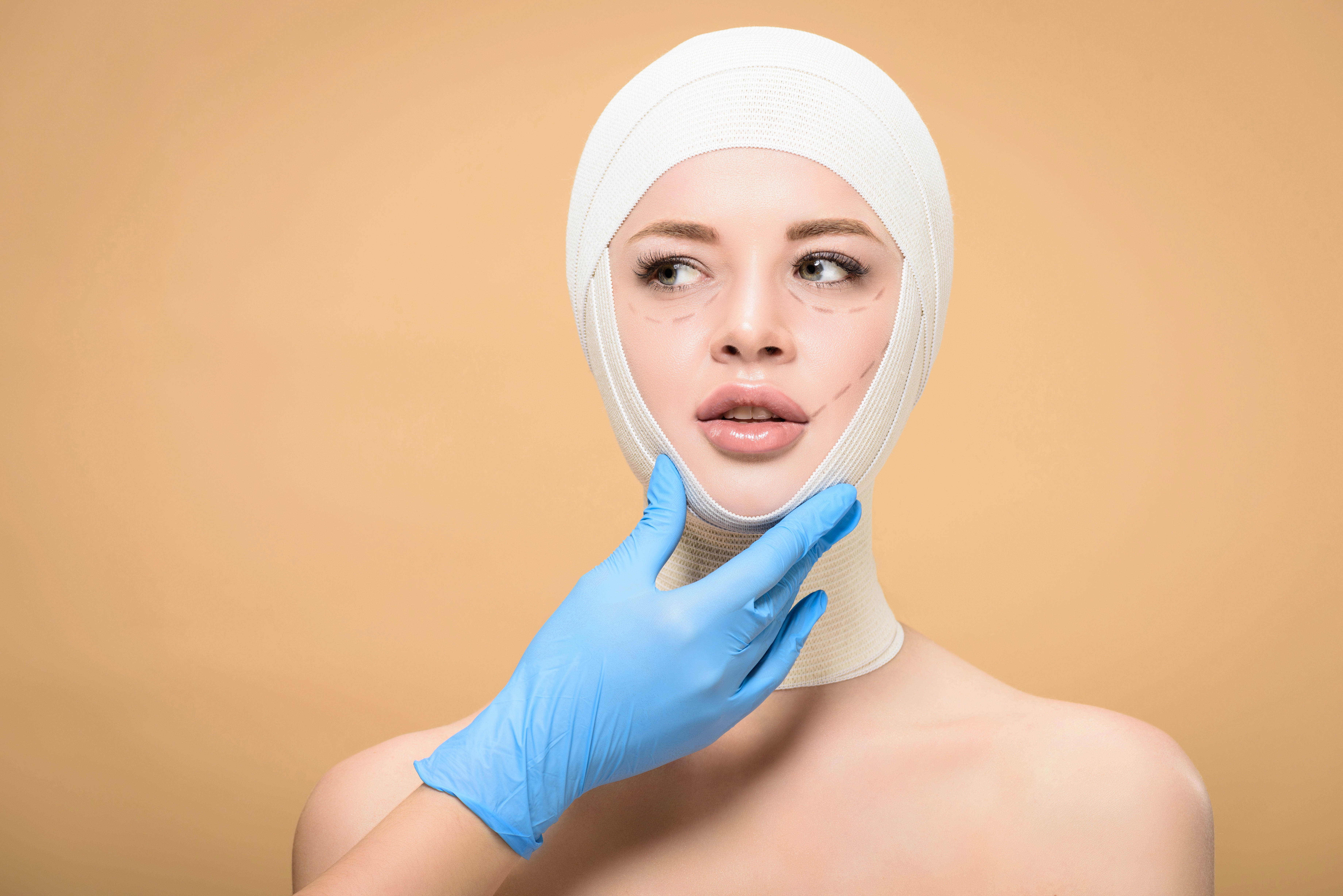 woman wrapped in facial bandages after a facelift procedure